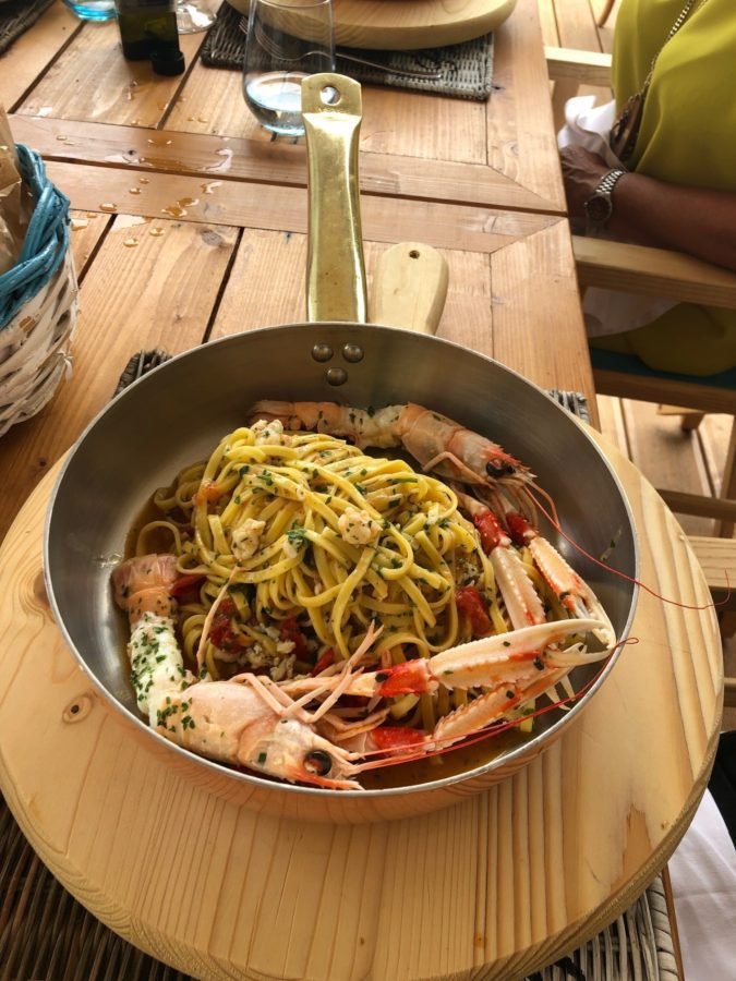 Food travel in Italy: A restaurant skillet with Puglia linguine agli scampi linguine pasta with king prawns