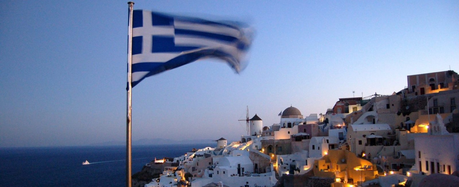 Greece Greek flag flies over Santorini lockdown