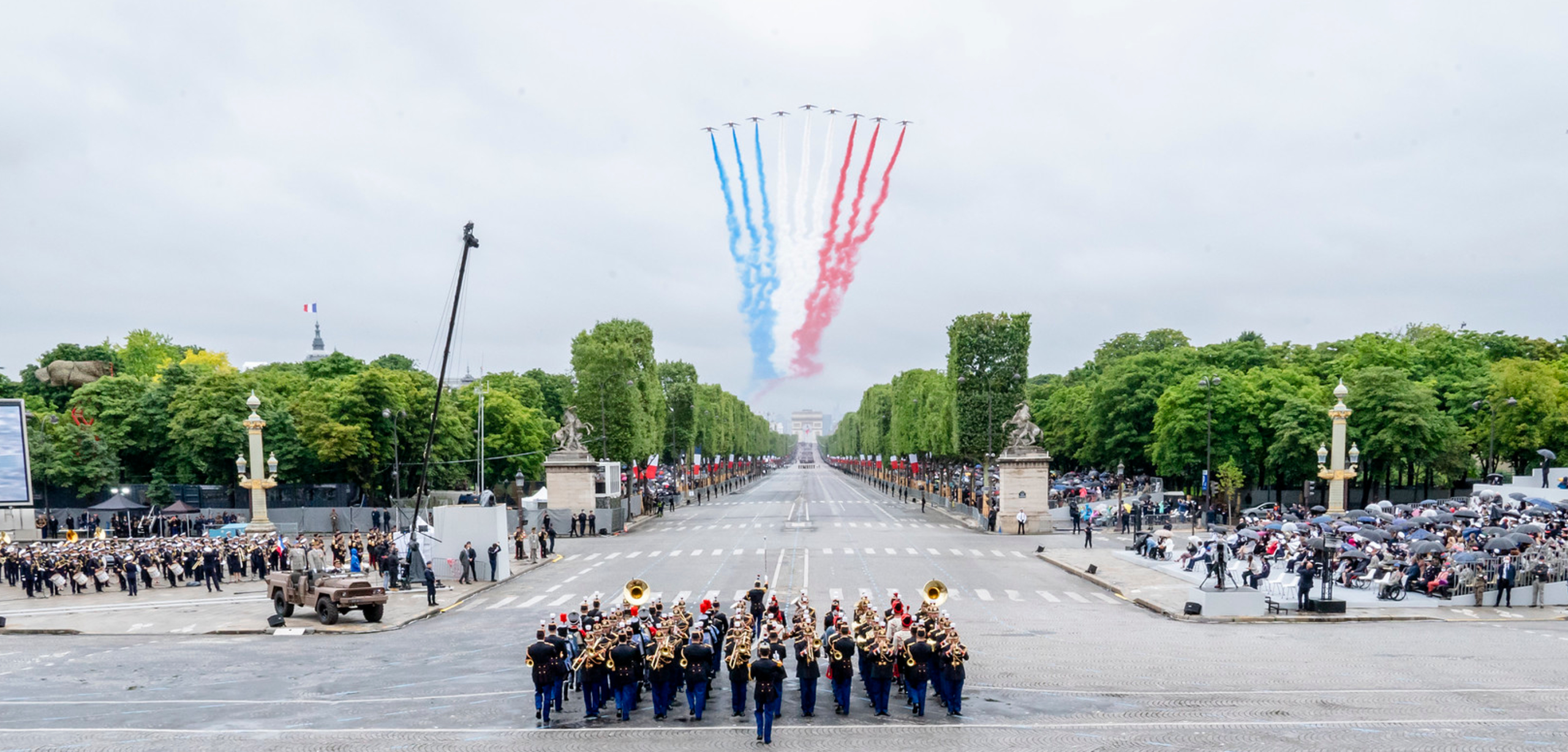 Bastille Day celebration Paris with French flag coloured trails in the sky left by jets