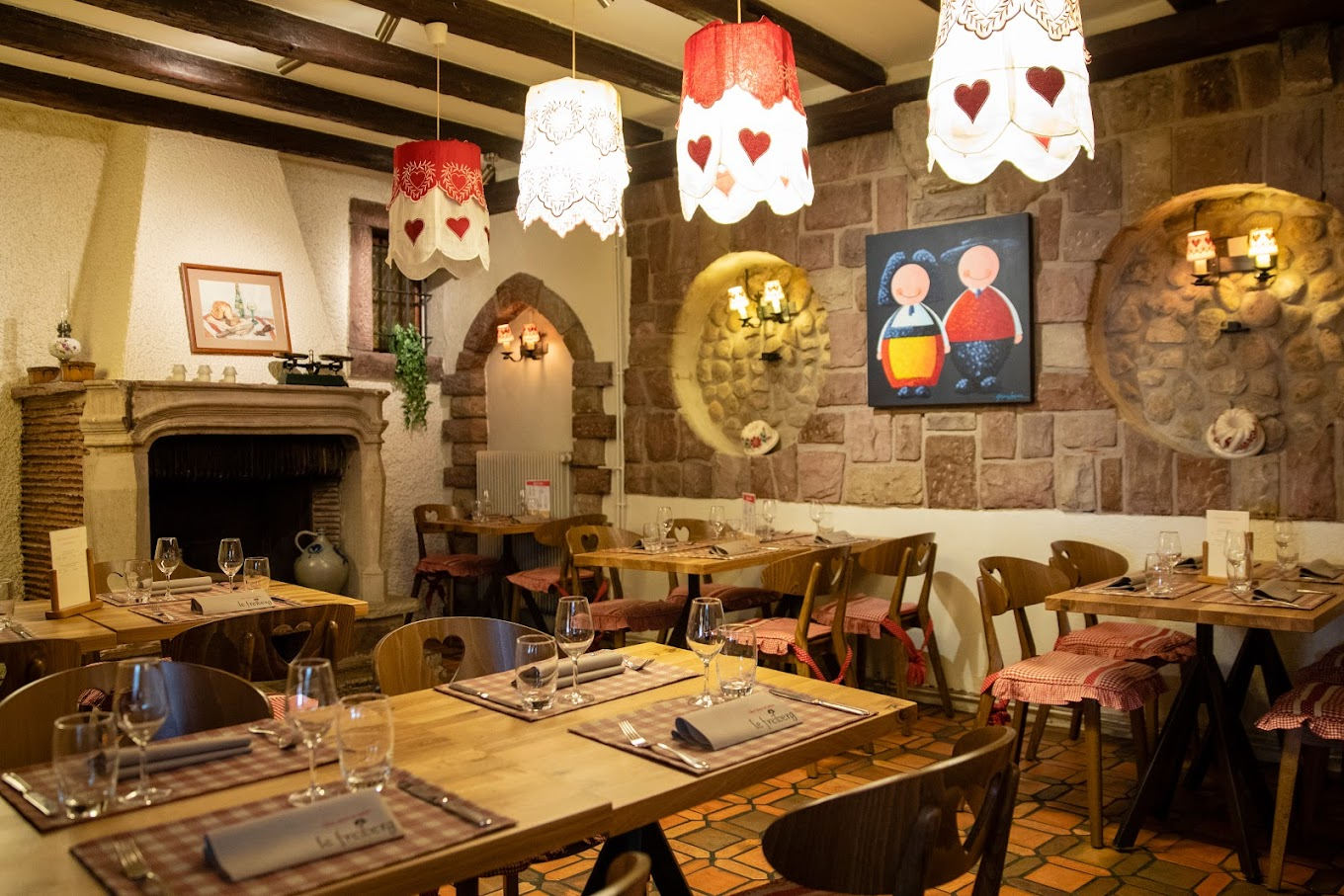 Lights, fireplace and cosy decoration in Le Freiberg winstub in Obernai on the Alsace Wine Route, France