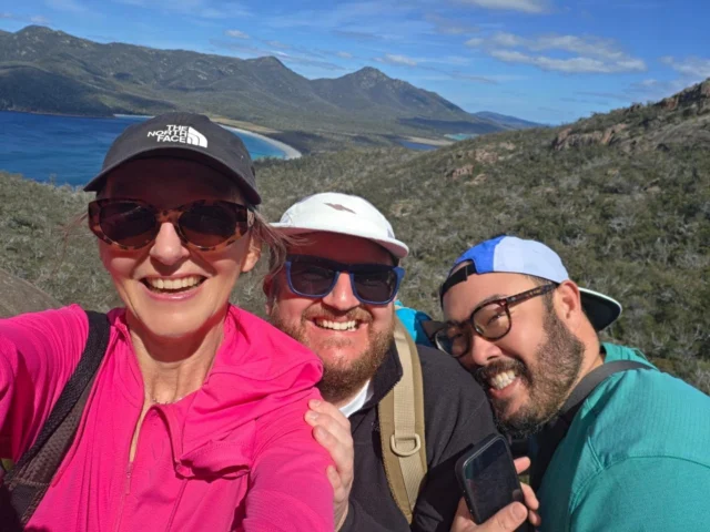 Friends ... and nature. Are there any better things in the world? And any better combination. Pure joy over this weekend with two Sydney friends (well, Sydney Scotsman and Sydney San Fran man) visiting me and my home isle.#travelwriter #tasmania #adventure #hiking #trekkingWhat a spectacular day to visit Freycinet – the beautiful granite forged peninsula on the East Coast where I spent so much time as a child at our humbled little shack – eating Christmas leftovers and living the life of Riley.#outdoors #landscapes #sceneryHilarity all round while kicking back on an architect designed bush recliner.#architecture #design #bush #treesGoing for maximum visibility in fuschia pink. A walking cherry blossom. Great Uniqlo sunproof design.Sweltering in Tasmania at 22°C.#uniqlo #pink #fuschia #friends #friendshipWineglass Bay. A chalice of deep blue and marbled turquoise waters?Or a blood stained burgundy coloured bay tainted by the whaling industry?I know which I prefer. But truth may rule over idealism.#writer #travelingram #travelgram #travelblog #travelbloggerThe boys were equally excited by the scenery as introducing me to the Tom Sawyer or Raiders of the Lost Ark like thrill if geocaching.And we had a great discovery, behind a little dried up waterfall on the way back from Wineglass Bay lookout, of a little collection of notes and and figurines in a box. It seems almost cultish to a newcomer, but in a very inoffensive way.#geocaching #rocks #naturelovers  #exploreThis geocache was a natural landmark. A pokémon like cave that my friend David got devoured by 🤣Let the fun begin. Of adventures within adventures. You can never have too many of them.It seems this strange rock shape was missed by the geocachers! 🤭Back down to safety, we visited Honeymoon Bay but there were no celebrations in sight ... just glorious blues ans rock art. Nature's art. Swirly patterns and magnificent colours.Oliver blended into the blues.#mountains #ocean #blue #wavesAnd David gave the last hurrah.#waves #blue